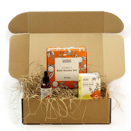 Box of Ancient Wisdom bath bombs set with a bottle and bar of soap on a white background