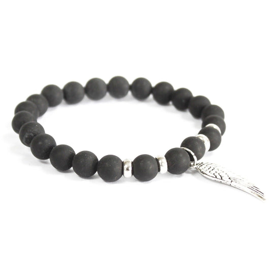 Black beaded bracelet with a silver fish charm on a white background