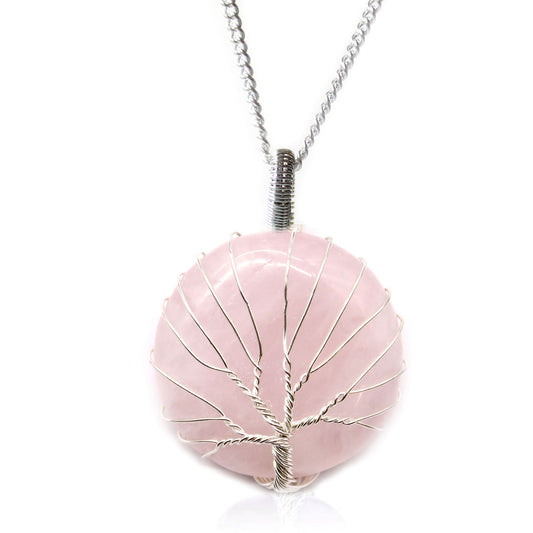 Pink stone pendant with silver tree design on a white background